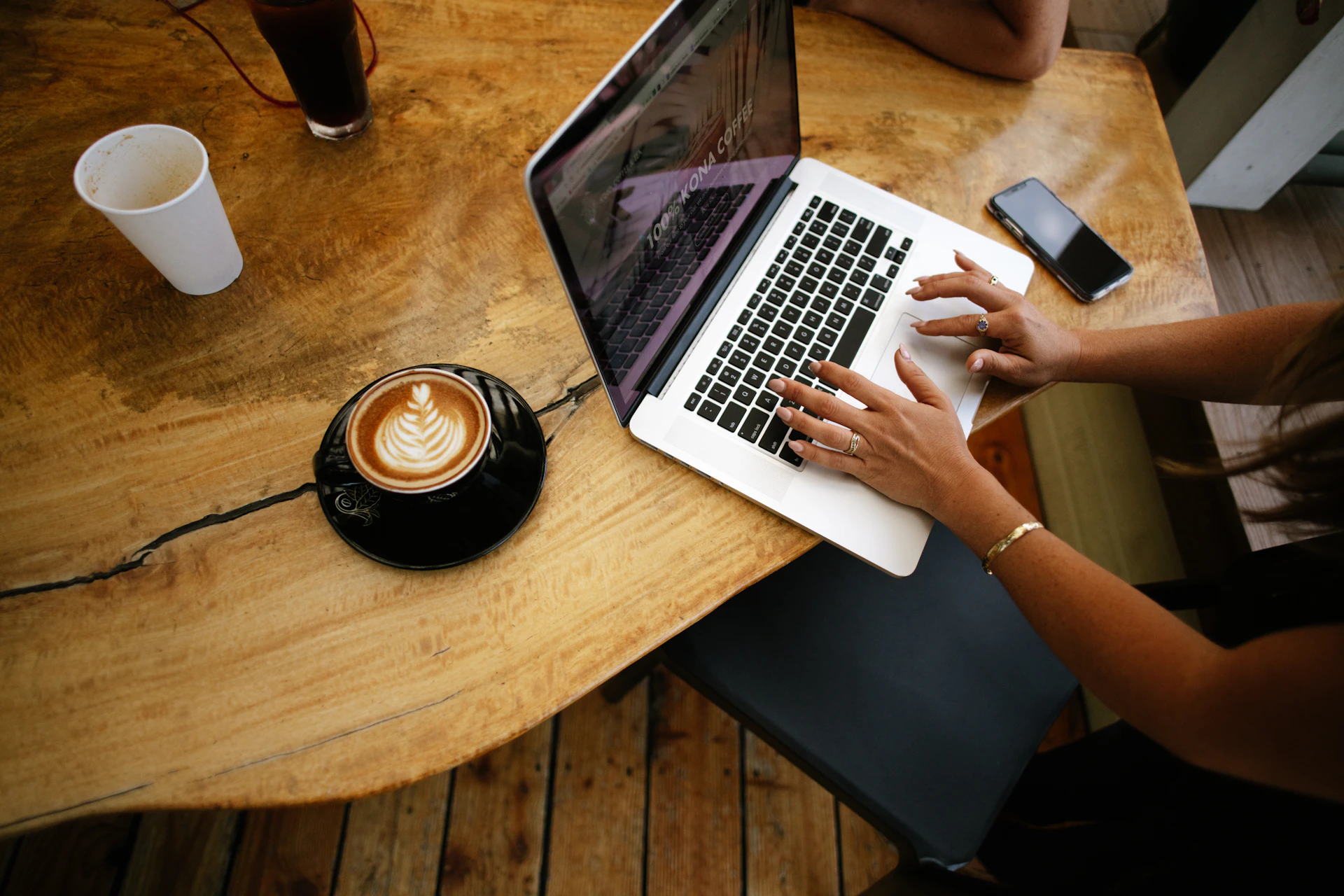 A small business owner taking a card payment beside a laptop